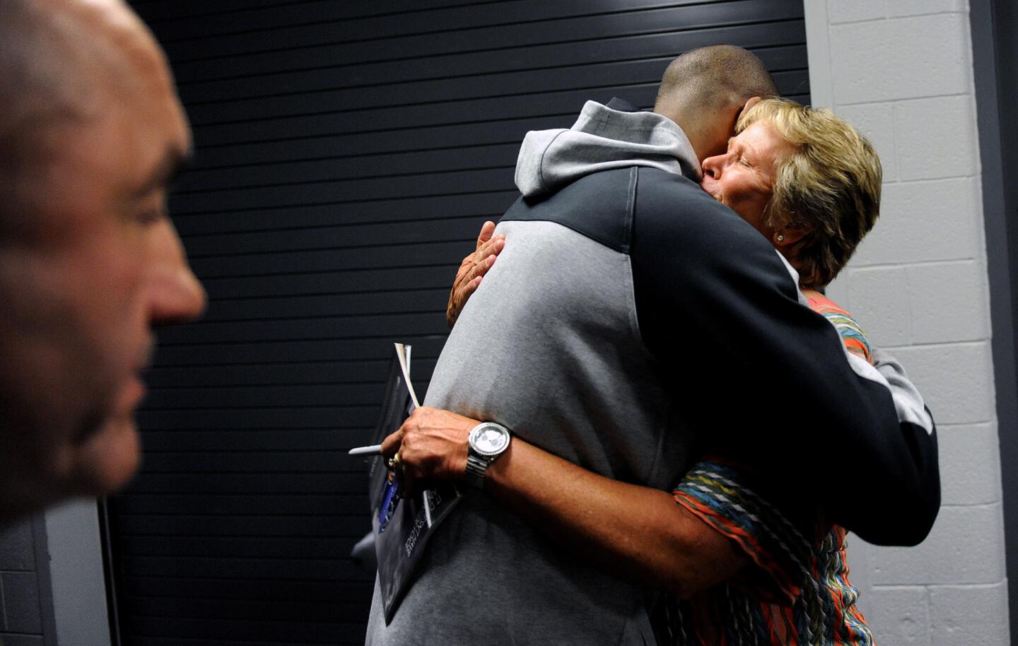 Former basketball legend Ann Myers hugs Lakers Kobe Bryant after a game against the Suns in Phoenix on March 23.