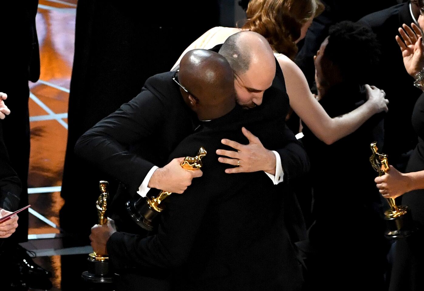"La La Land" producer Jordan Horowitz hands over the best picture award to "Moonlight" writer-director Barry Jenkins after a presentation error onstage.