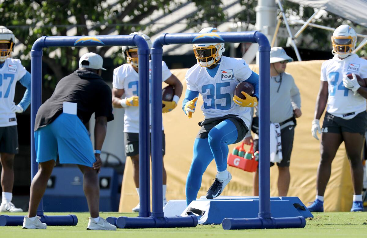Running back Larry Rountree III high-steps through an obstacle during Chargers training camp on Wednesday in Costa Mesa.