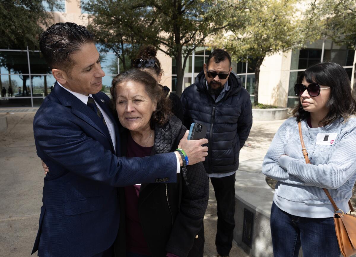 Deputy Dist. Atty. Jonathan Hatami, left, hugs Eva Hernandez following a pretrial hearing in Lancaster.
