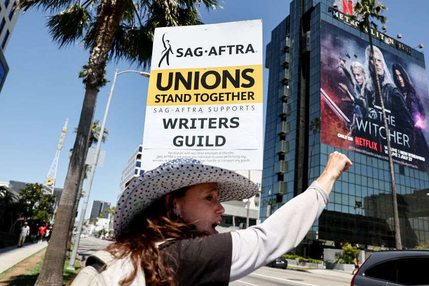 LOS ANGELES, CALIFORNIA - JULY 12: SAG-AFTRA member Christine Robert pickets in solidarity with striking WGA (Writers Guild of America) workers outside Netflix offices on July 12, 2023 in Los Angeles, California. Members of SAG-AFTRA, which represents actors and other media professionals, may go on strike by 11:59 p.m. today which could shut down Hollywood productions completely with the writers in the third month of their strike against Hollywood studios. (Photo by Mario Tama/Getty Images)