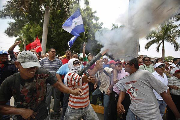 Supporters of the Sandinista National Liberation Front fire homemade mortars at a hotel in the Nicaraguan capital where opposition lawmakers were meeting to try to overturn a presidential decree unilaterally extending the terms of two Supreme Court justices.