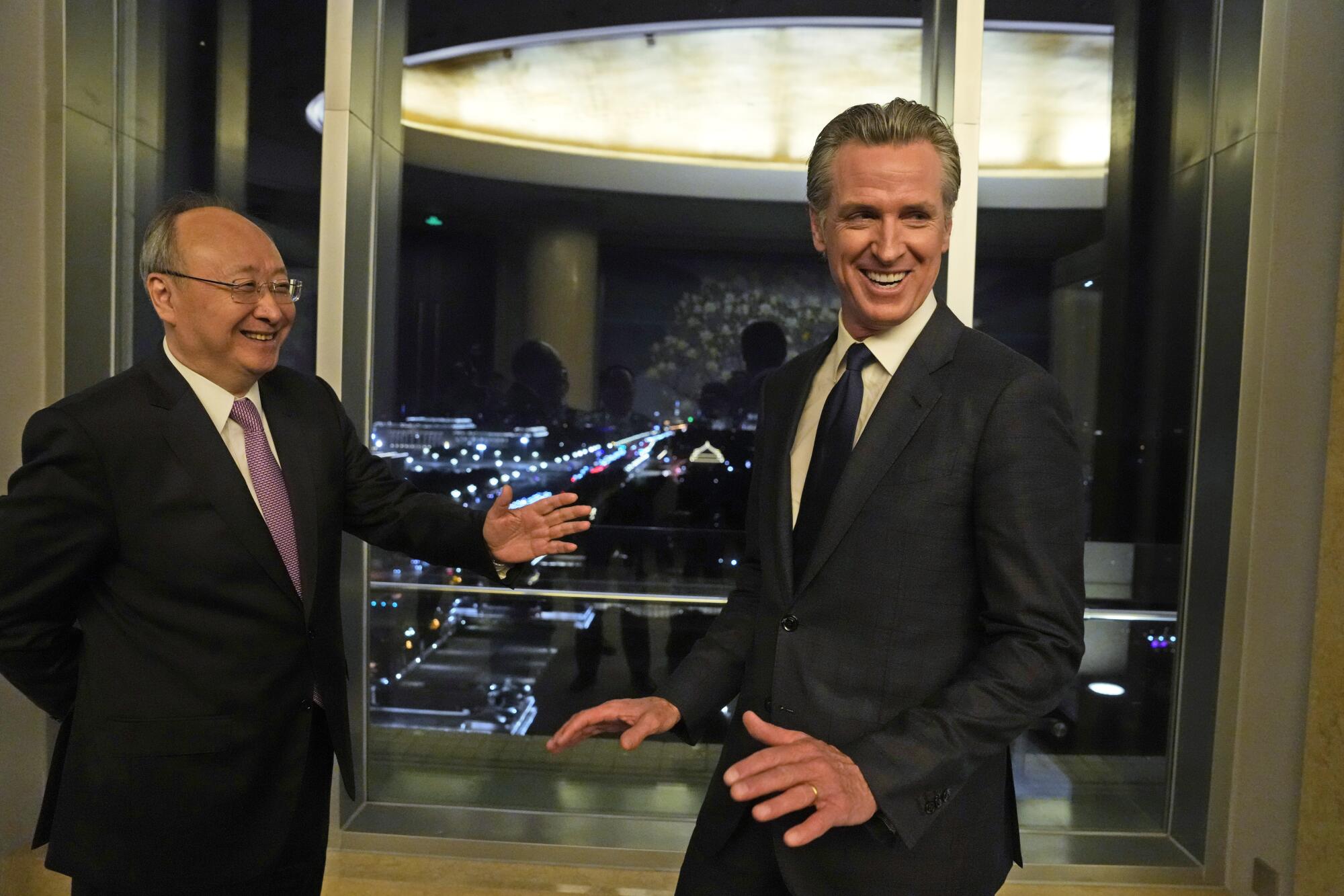 Gov. Gavin Newsom with a Chinese official in a building lobby