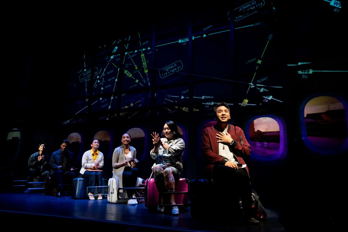 Actors sit on airplane seats on stage in "On This Side of the World."