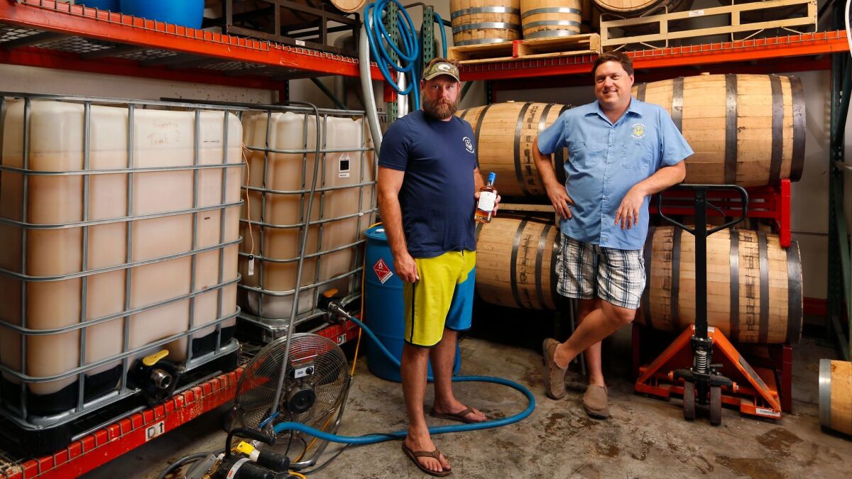 Bill Rogers, right, is the founder of Liberty Call Distilling Co. and head of the San Diego Distillers Guild, shown with distiller Steve Grella.