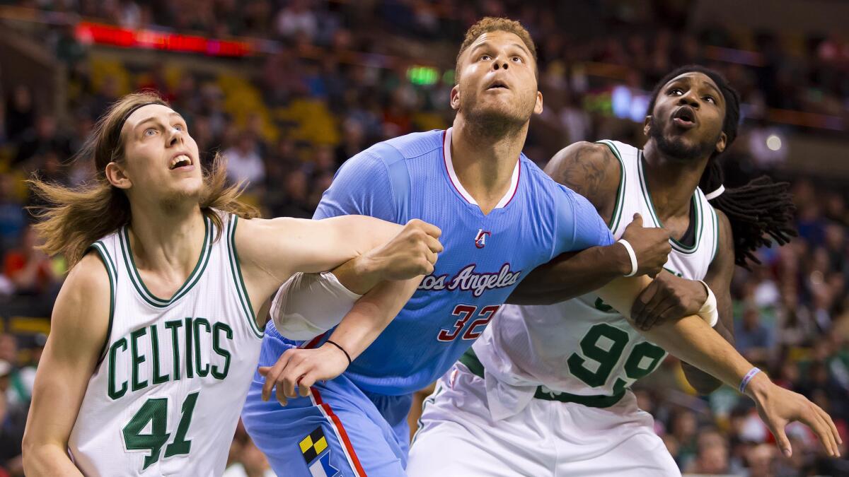 Clippers forward Blake Griffin, center, is boxed out by Boston Celtics teammates Kelly Olynyk, left, and Jae Crowder during the Clippers' 119-106 victory Sunday.