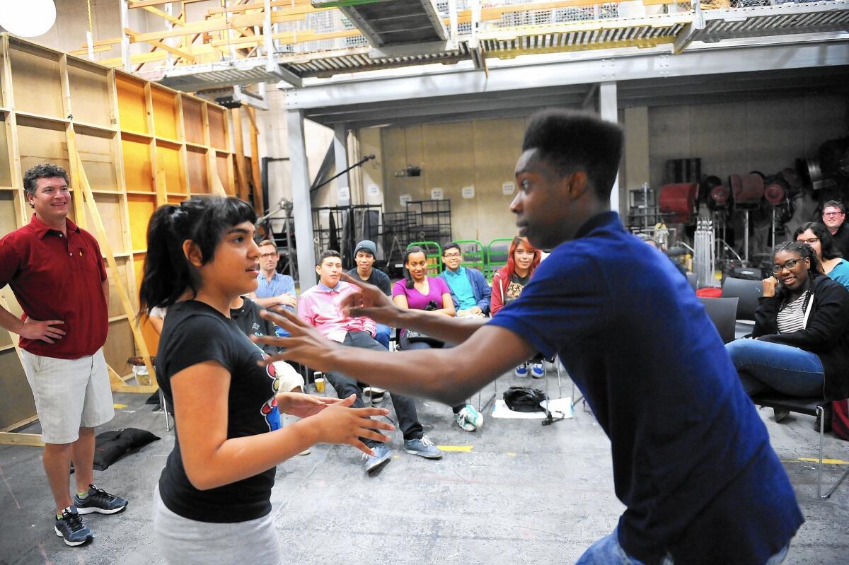 Actor Pat Finn, far left, watches as high school students Francis Arana and Jevonne Davis, right, participate in an improv class for 14 high school students at Loyola Marymount University on July 22, 2015.