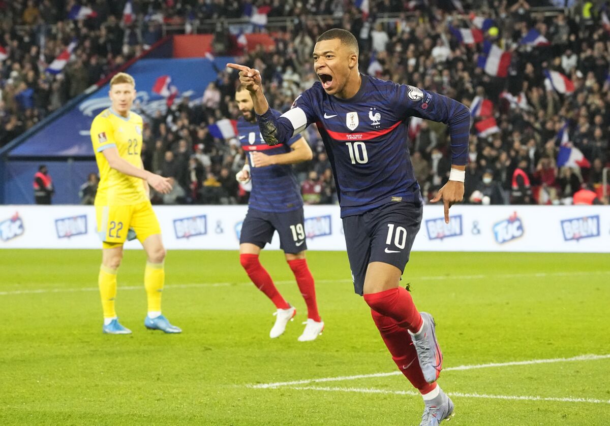 France's Kylian Mbappe celebrates after scoring his side's second goal during the World Cup 2022 group D qualifying soccer match between France and Kazakhstan at the Parc des Princes stadium in Paris, France, Saturday, Nov. 13, 2021. (AP Photo/Michel Euler)