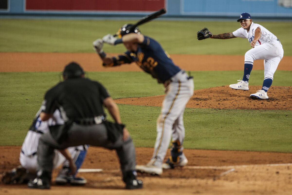 Dodgers reliever Julio Urias pitches to Milwaukee Brewers right fielder Christian Yelich.