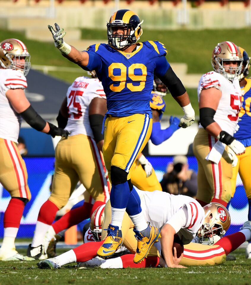 Rams Aaron Donald celebrates his sack of 49ers quarterback Nick Mullens.