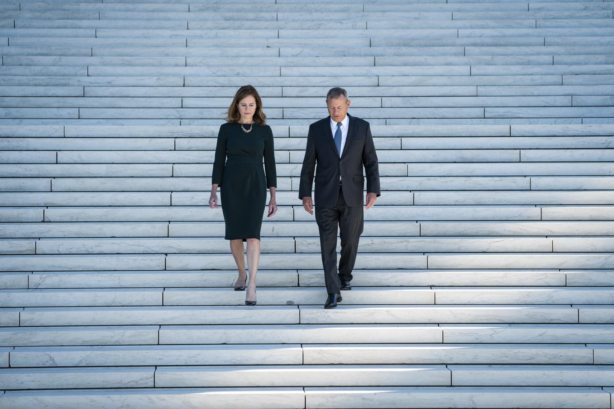 Justice Amy Coney Barrett with Chief Justice John G. Roberts Jr. walking down the steps of the Supreme Court