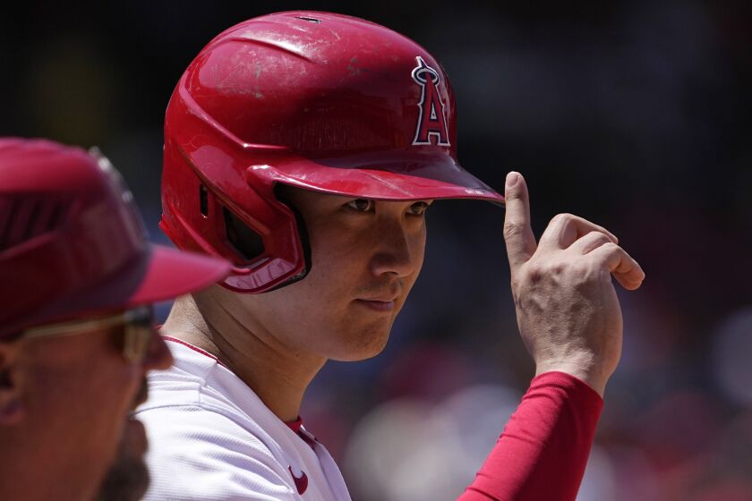 Los Angeles Angels' Shohei Ohtani acknowledges the first base umpire after he was intentionally walked.