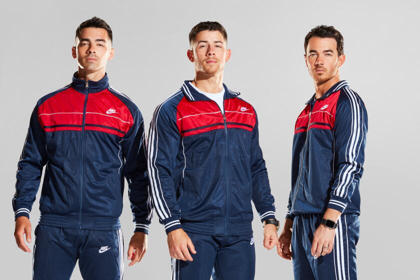 Joe Jonas, Nick Jonas and Kevin Jonas sport matching track suits