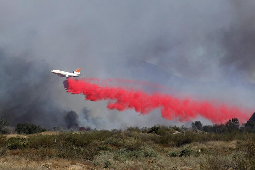 SANTA PAULA CA NOVEMBER 1, 2019 -- A plane drops fire retardant on the Maria fire as seen from in between Santa Paula and Saticoy Friday, Nov. 1, 2019. (Mel Melcon / Los Angeles Times)