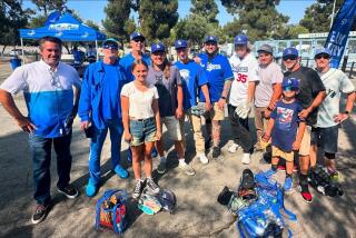 Tony Voda, fifth from left with the cat t-shirt, hangs out with the Dodgerhawks before a game.