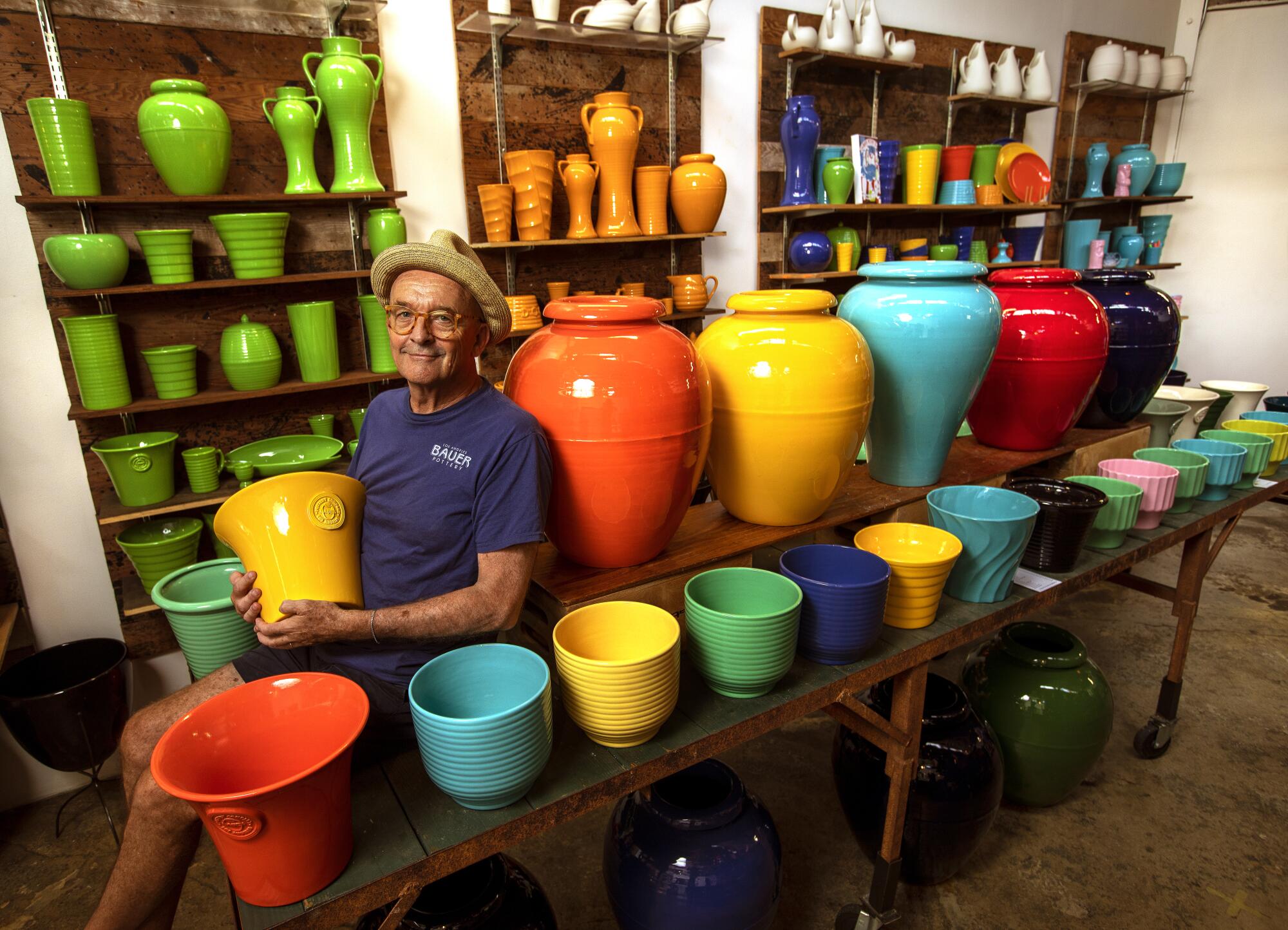 Janek Boniecki is photographed in his showroom among colorful pots