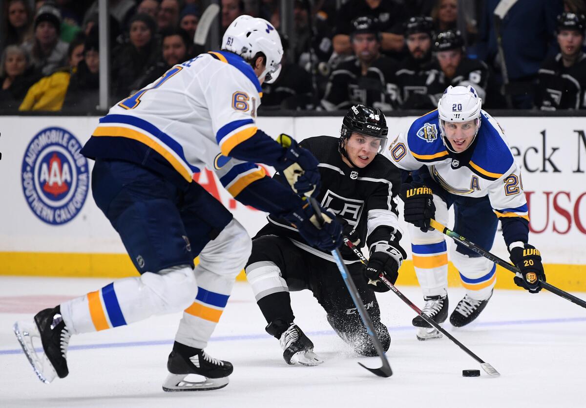 Kings forward Blake Lizotte tries to control the puck.