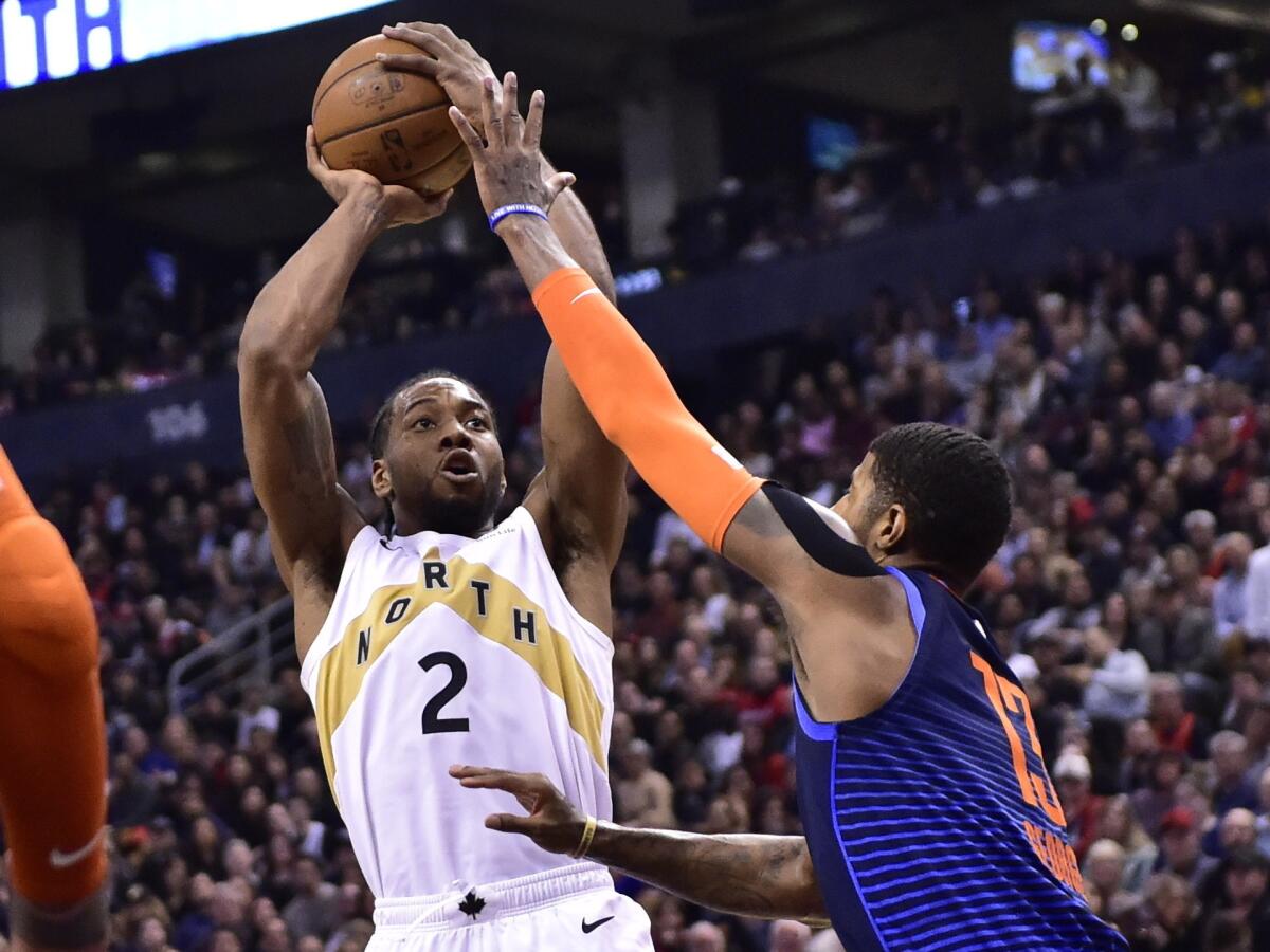 Paul George attempt to block a shot by Kawhi Leonard during a Thunder-Raptors game last season.