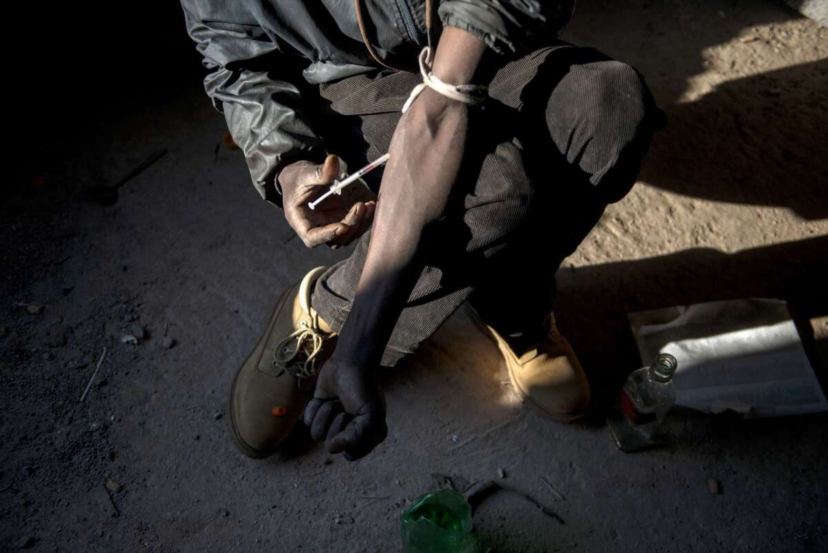 A nyaope addict injects himself in an abandoned building in Simuneye township on the outskirts of Johannesburg.