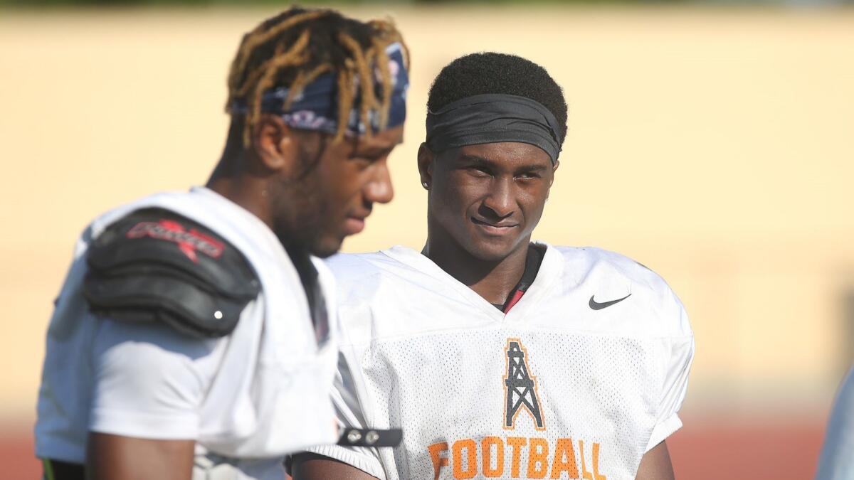 Standouts Jeremiah Flanagan, left, and Arick McLawyer, right, are two key returning starters for the Huntington Beach High football team.