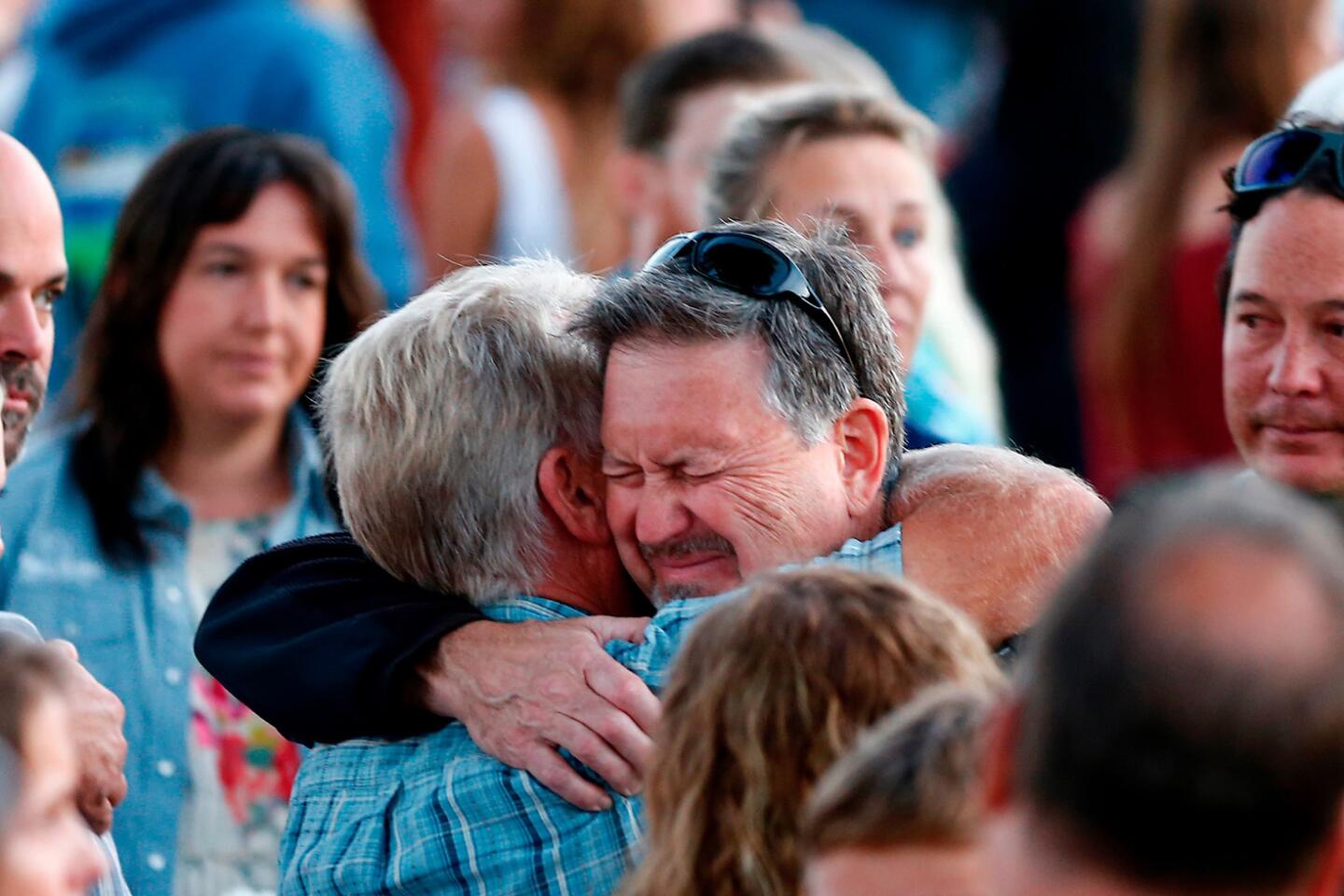 Glen Fritzler, left, co-owner of Truth Aquatics and the dive boat Conception, consoles an attendee during a vigil at Chase Palm Park in Santa Barbara on Friday evening.