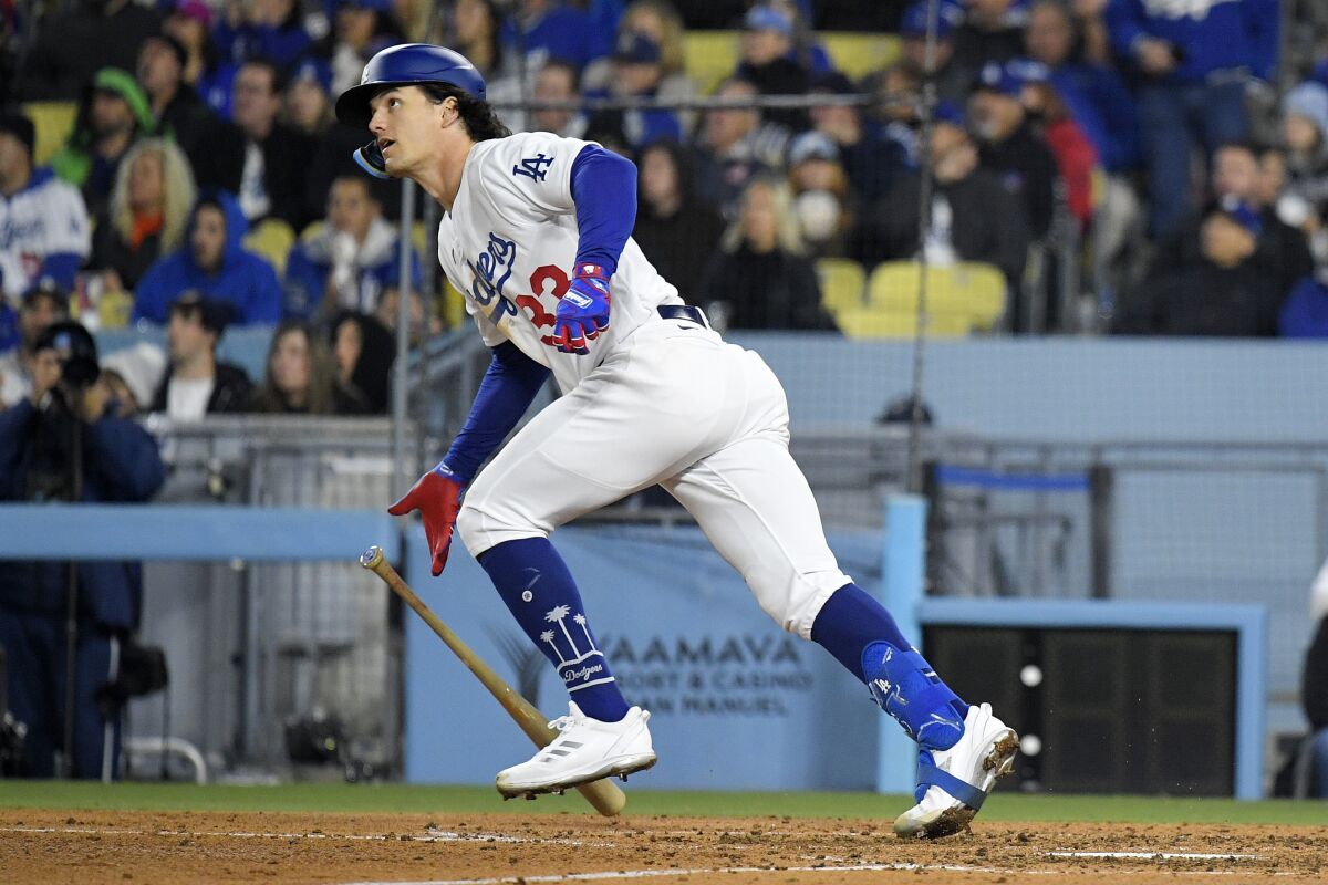 Los Angeles Dodgers' James Outman, left, runs to first as he hits a two-run home run during the sixth inning of an opening day baseball game against the Arizona Diamondbacks Thursday, March 30, 2023, in Los Angeles. (AP Photo/Mark J. Terrill)