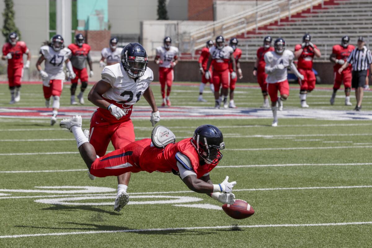 Liberty University receiver Shedro Louis misses a catch in front of defensive back Marcellous Harris during an intrasquad scrimmage at Williams Field. 