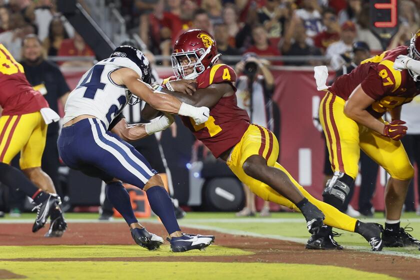 USC running back Woody Marks scores a touchdown as Utah State strong safety Jordan Vincent tries to stop him