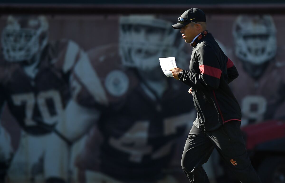 USC interim head coach Donte Williams runs on the field during a team practice session on Sept. 15.