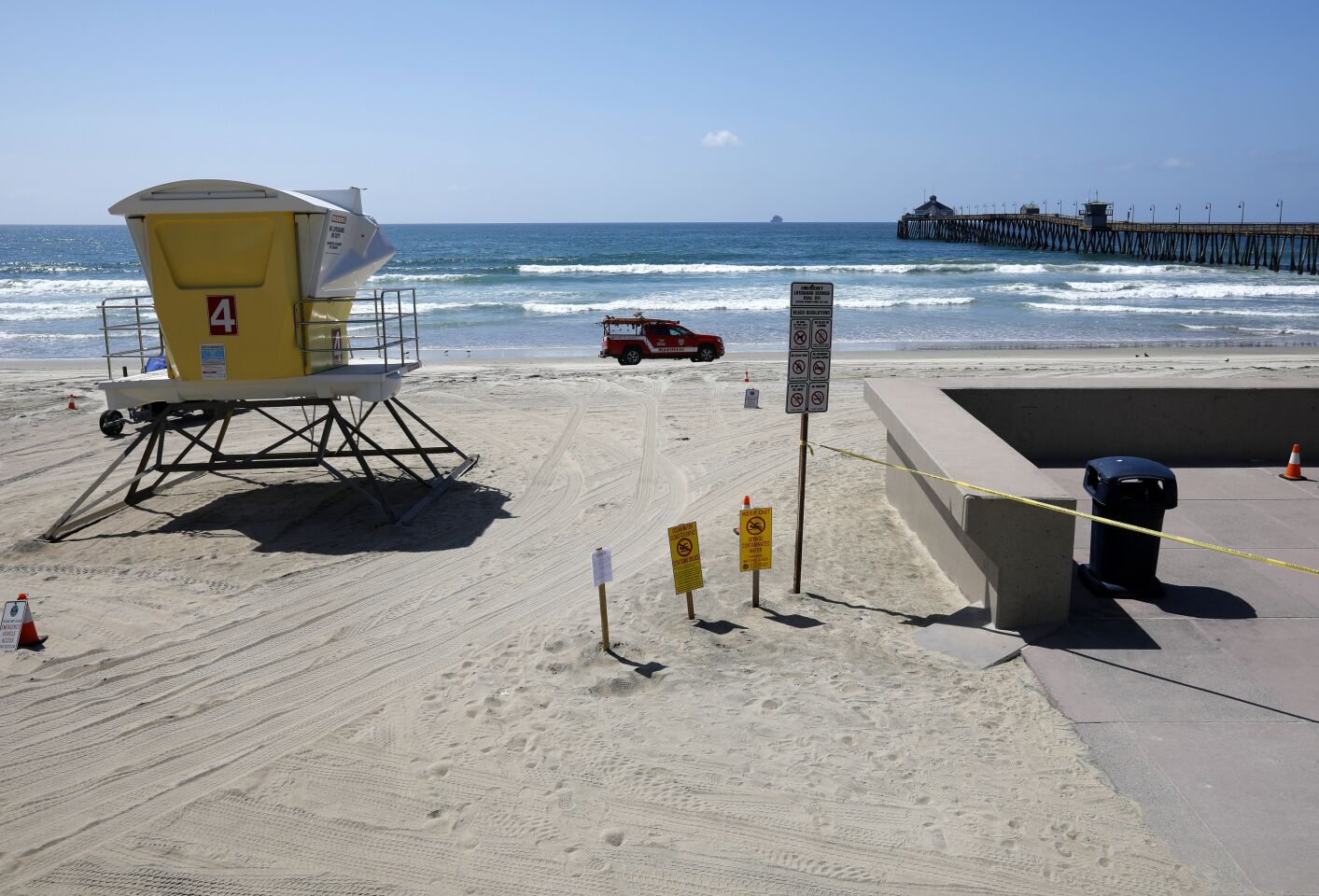 An Imperial Beach lifeguard patrols the beach, which along with the pier was closed to the public due to the coronavirus on March 29, 2020.