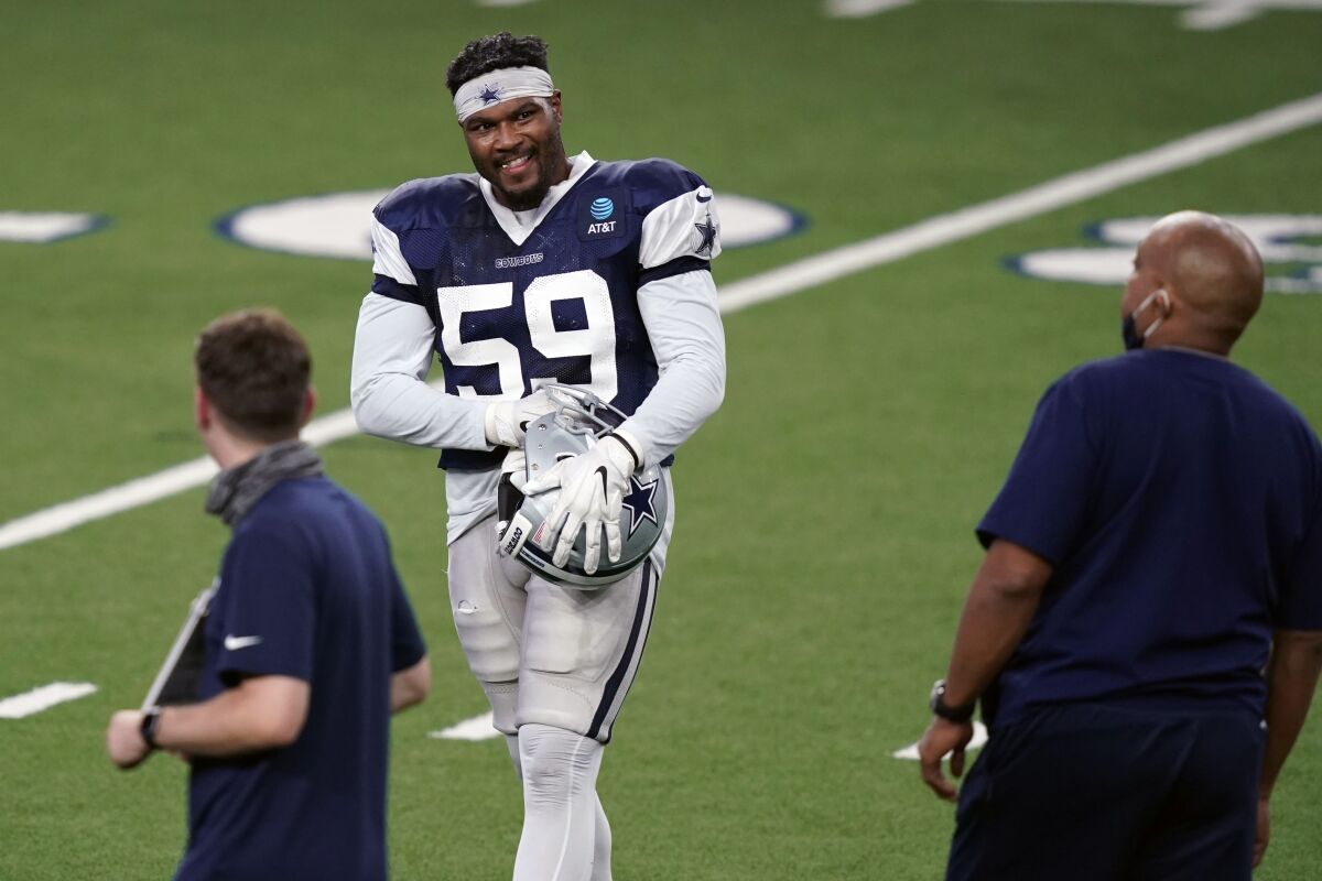 Dallas Cowboys defensive end Justin March (59) smiles as he prepares for drill during an NFL football training camp practice in Frisco, Texas, Monday, Aug. 31, 2020. (AP Photo/LM Otero)