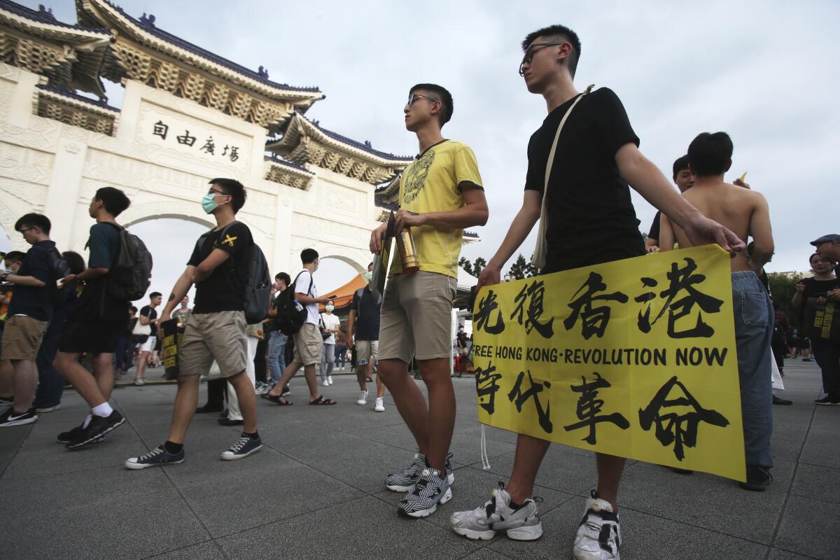 Hong Kong protesters and Taiwanese supporters gather Saturday in Taipei, Taiwan.