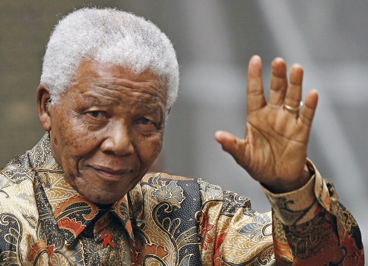 Nelson Mandela is seen waving to the media while in London in 2007.
