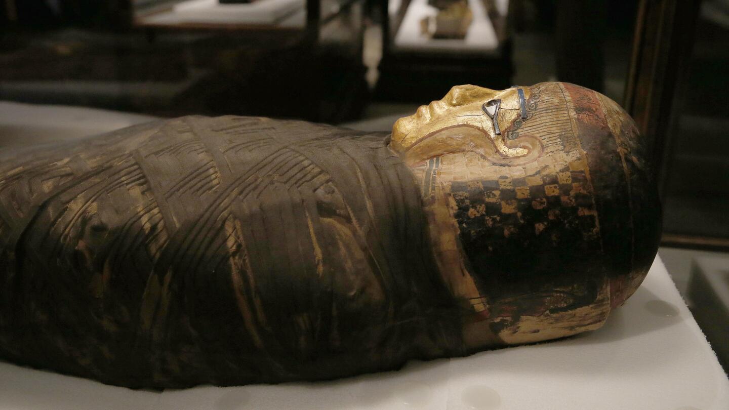 The remains of a middle-aged Egyptian woman in a cartonage (linen and glue) headress and wrappings from the Roman period (30 BC to 395 AD) is featured in the "Mummies: New Secrets From the Tombs" exhibition at the Natural History Museum of Los Angeles County.