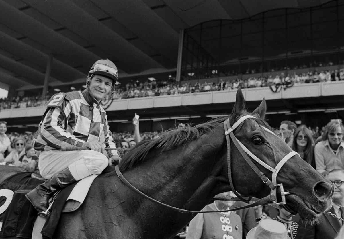 Jockey Ron Turcotte rides Secretariat toward the winners circle after they captured the Triple Crown.