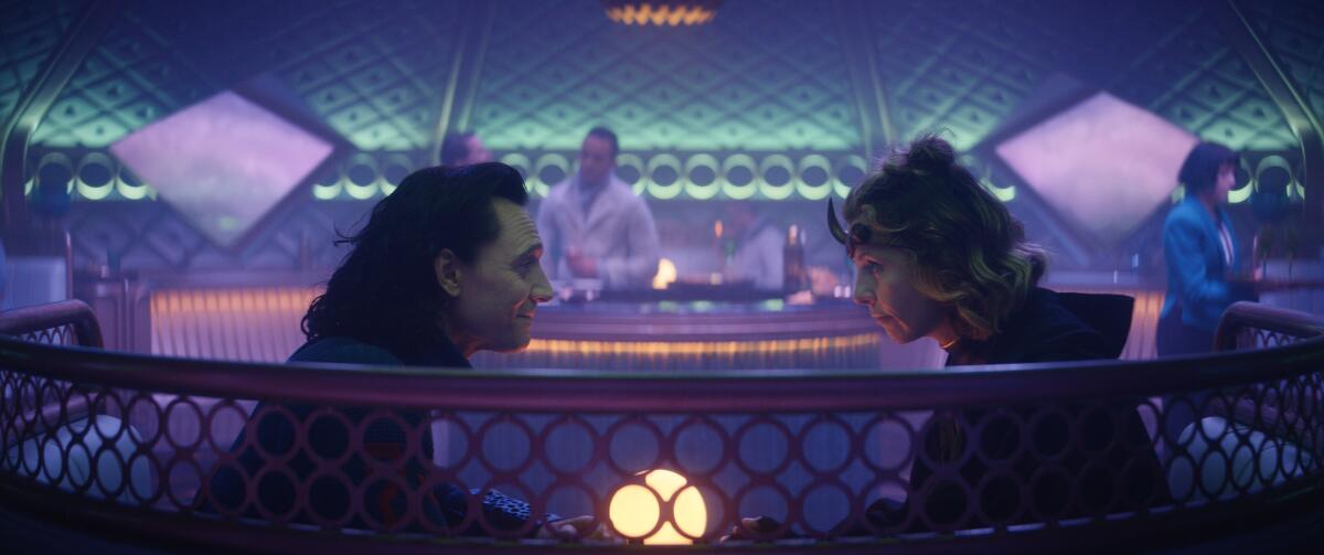 A man and a woman sitting facing each other in a booth