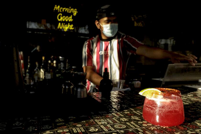 Alejandro De Anda finishes preparing a Cucumberita drink at Morning Nights’ restaurant.