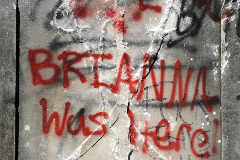 Graffiti runs across the base of a 50-foot-tall obelisk that stood as a Confederate monument in Birmingham, Ala.