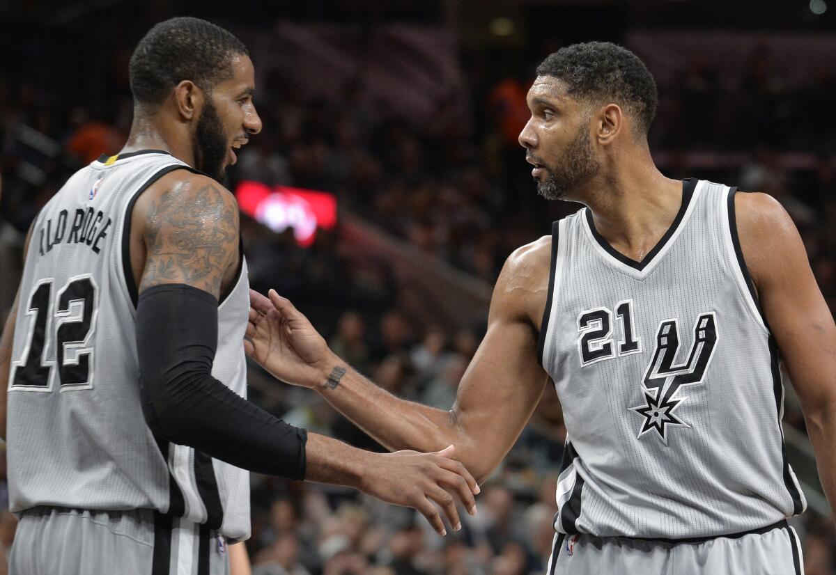 San Antonio forward Tim Duncan (21), seen with Spurs teammate LaMarcus Aldridge in March, had career success comparable to Kobe Bryant's, but on a much quieter level.