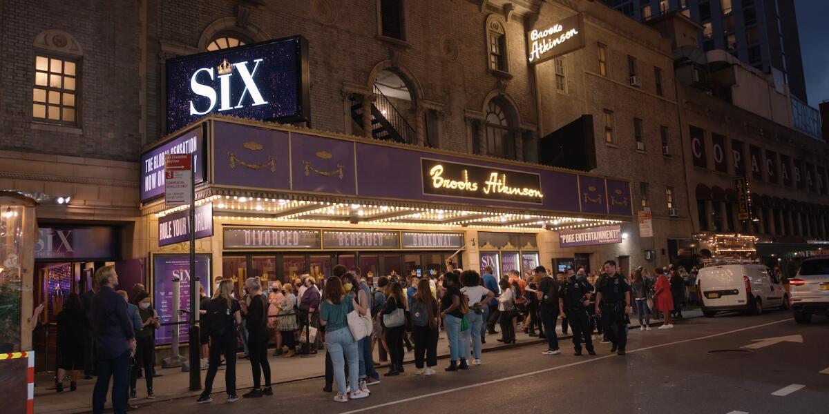 A crowd stands outside the Brooks Atkinson Theater in New York City, seen in the documentary "Broadway Rising."