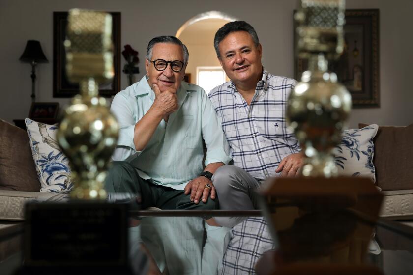 SAN MARINO-CA-AUGUST 18, 2020: Dodger broadcaster Jaime Jarrin, left, and his son Jorge are photographed with their Golden Mike awards for excellence in radio news coverage at home in San Marino on Tuesday, August 18, 2020. (Christina House / Los Angeles Times)