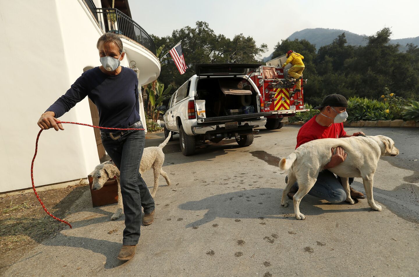Mary McEwen and husband Dan Bellaart prepare to evacuate their home on Toro Canyon Road in Montecito as the Thomas fire burns.