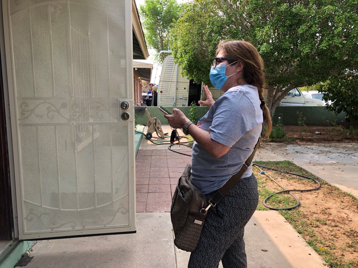 A volunteer canvasses door-to-door in Phoenix
