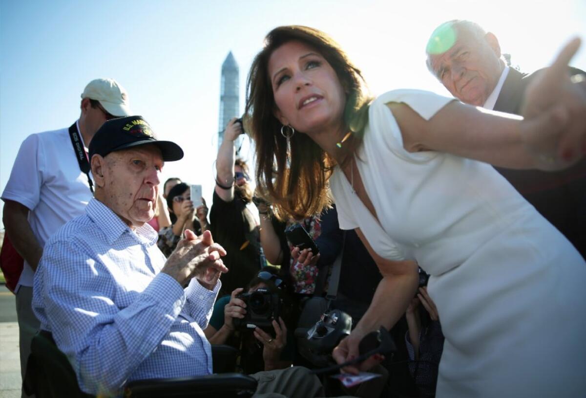 Rep. Michele Bachmann (R-Minn.) comforts a World War II veteran victimized by the government shutdown she supports.