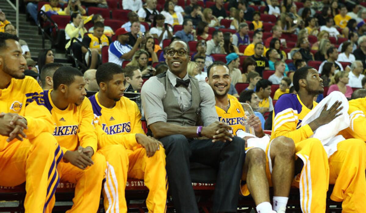Lakers center Dwight Howard jokes with teammates on the bench in a game against the Warriors earlier this month.