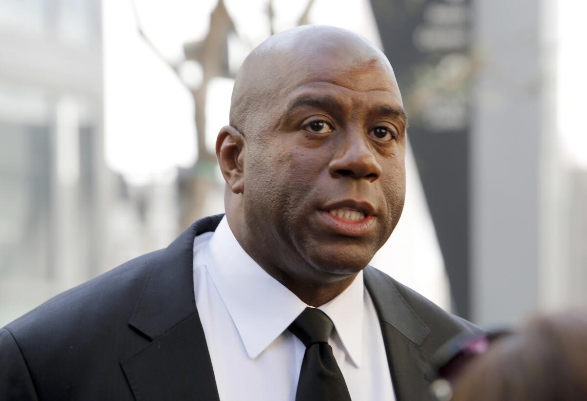 Earvin "Magic" Johnson arrives at a memorial service for Jerry Buss in Los Angeles. Johnson is calling upon NBA Commissioner Adam Silver to "come down hard" on Los Angeles Clippers owner Donald Sterling, who is alleged to have made racially charged comments. Johnson was a subject of the comments Sterling allegedly made on an audio recording obtained and released by TMZ.
