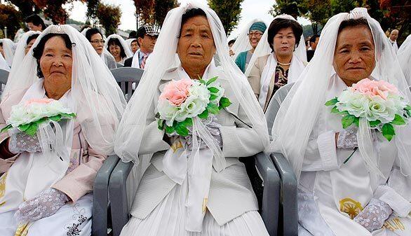 Elderly South Korean brides wait for the mass wedding ceremony to begin.