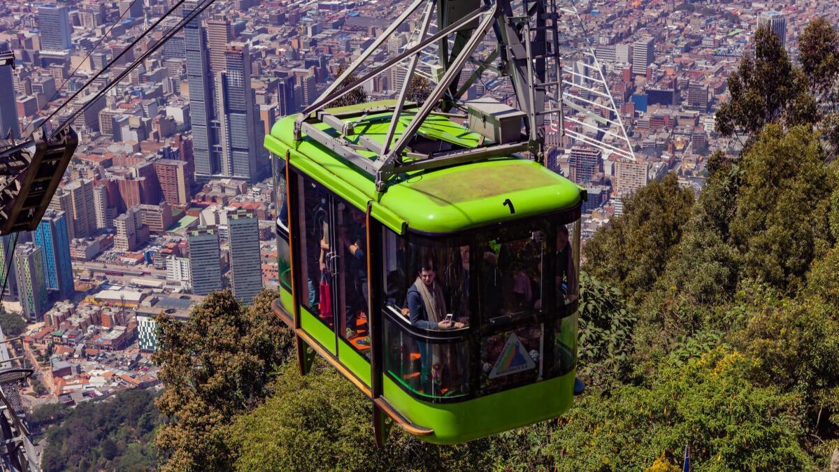 A cable car carrying tourists approaches the peak of Monserrate in Bogota, Colombia, about 1,500 feet above the capital city.
