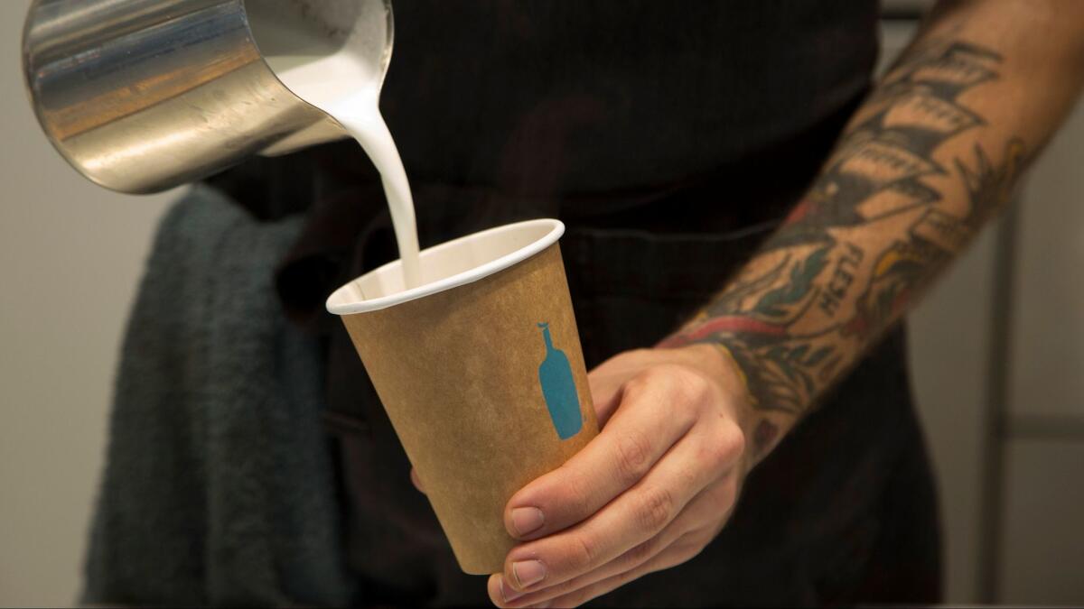 A server prepares a cappuccino at Blue Bottle in downtown Los Angeles.