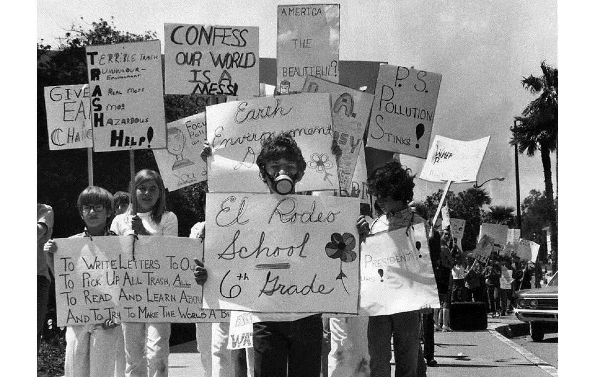 Sixth-grader Brad Frank, 11, wearing a gas mask, joins about 100 classmates during an Earth Day march on Wilshire Boulevard on the first Earth Day, April 22, 1970.